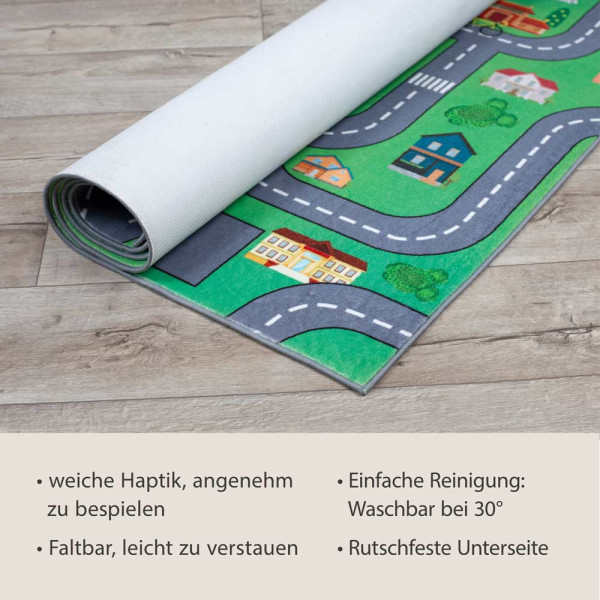 Spielteppich mit bunten Motiven einer Stadt, Straßen, Fahrzeugen und Spielplätzen, die Kindern das Spielen und Entdecken ermöglichen.