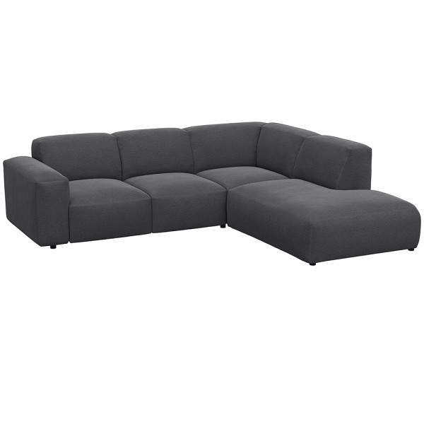 Graues, modulares Sofa LUCERA mit offener Ecke steht dekorativ. Es bietet bequeme Sitzmöglichkeiten und passt sich dem Raumdesign an. Ideal für eine stilvolle Inneneinrichtung.