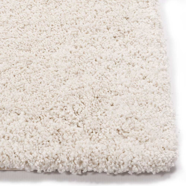 Weißer, hochfloriger Teppich mit samtiger Oberfläche liegt flach auf dem Boden. Die Struktur zeigt weiche, dichte Fasern. Der Teppich eignet sich für individuelle Maßanfertigung und ist in verschiedenen Farben erhältlich.