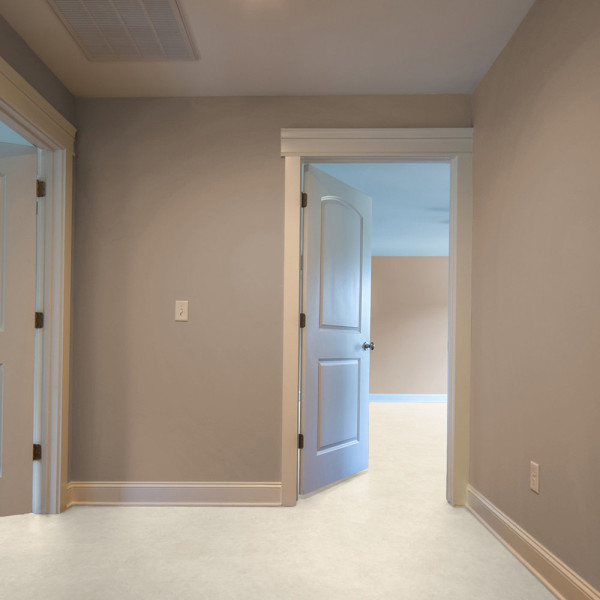 Helle, strukturierte Designbodenfläche in einem neutralen Beige-Ton. Die Oberfläche vermittelt den Eindruck von Stein und eignet sich für Wohn- und Geschäftsräume.