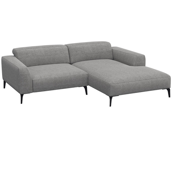 Beige Chaiselongue-Sofa mit klaren Linien und niedrigem Rücken, bestehend aus strapazierfähigem Material. Es bietet eine geräumige Liegefläche und elegante, schwarze Beine.
