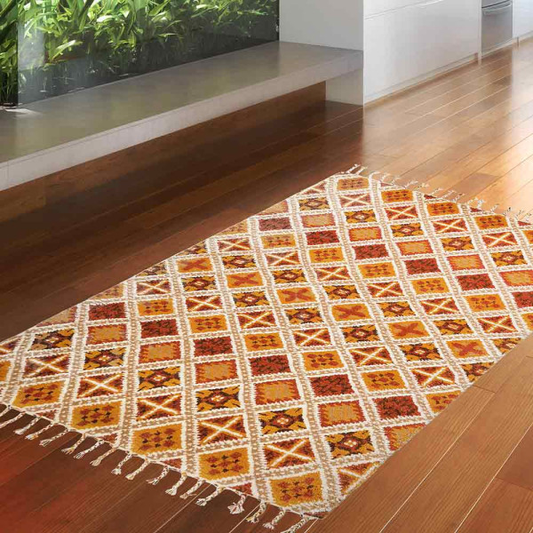 Terracottafarbener Teppich mit geometrischem Muster in gelb, rot und grün. Der Teppich hat Fransen an der Oberkante und misst 170 x 240 cm.