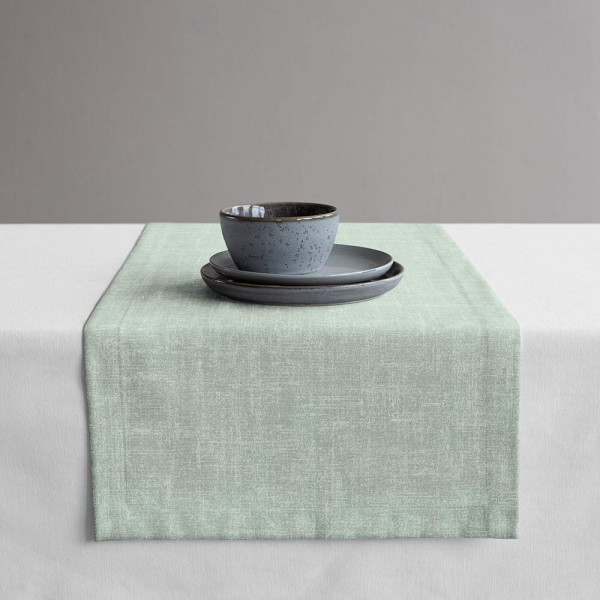 Mintfarbener, strukturierter Gardinenstoff des Typs Tingley liegt schräg gefaltet. Die Oberfläche erscheint glatt und leicht glänzend. Der Stoff eignet sich für individuelle Maßanfertigungen.