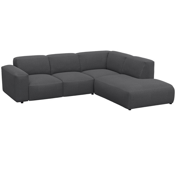 Graues, modulares Sofa LUCERA mit offener Ecke steht dekorativ. Es bietet bequeme Sitzmöglichkeiten und passt sich dem Raumdesign an. Ideal für eine stilvolle Inneneinrichtung.